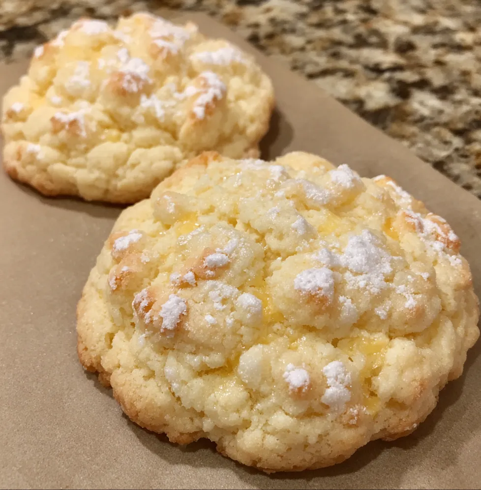 Close-up of golden cream cheese cookie with tender crumb and sugar dusting.
