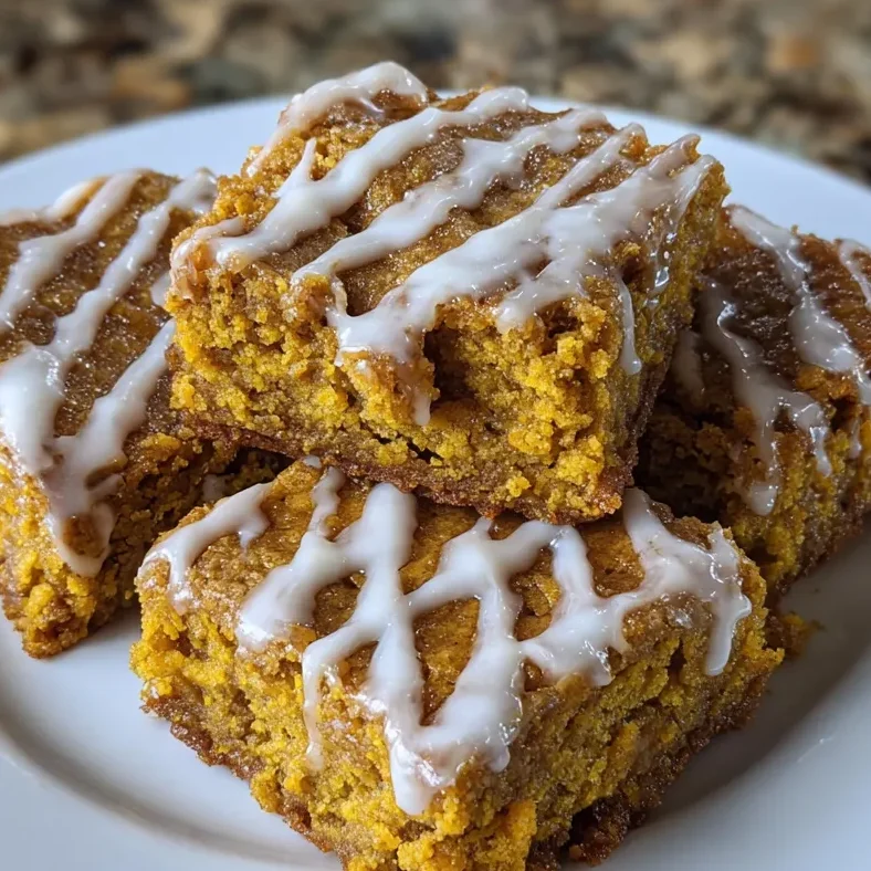 Plate of blondie squares served with coffee and cinnamon sticks.